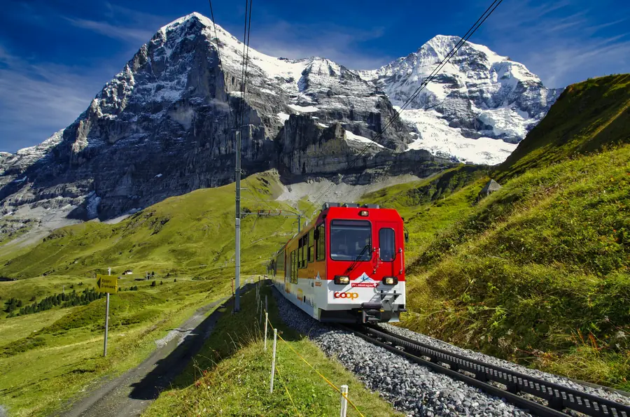 A red mountain train in the Swiss Alps